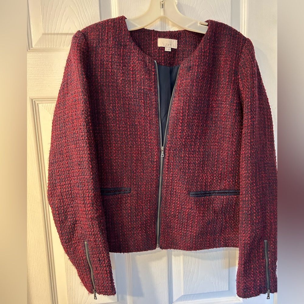 Cropped magenta and navy jacket with zipper details.